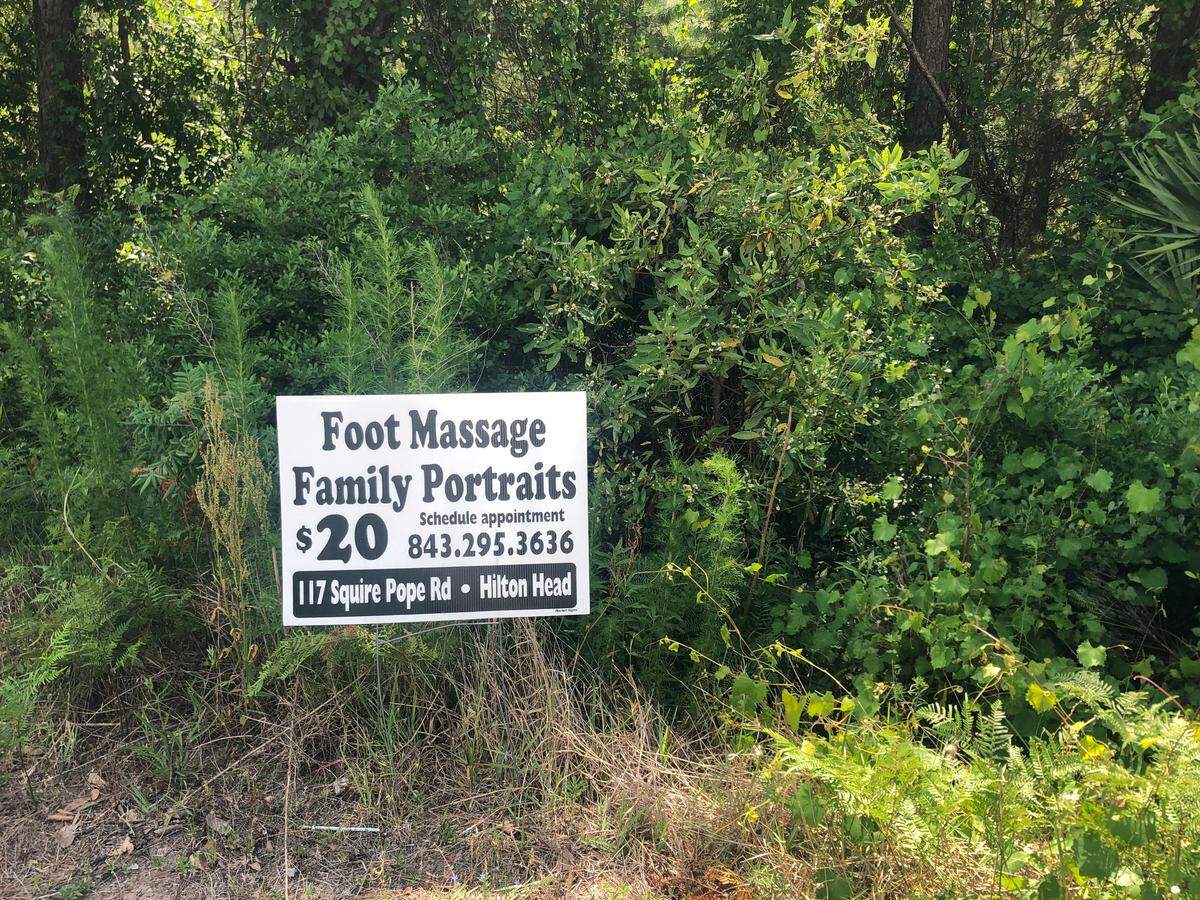 A sign advertising foot massages and family portraits sits next to Bluffton Parkway in Bluffton May 20, 2019. The sign advertises services provided by Sea Island Massage on Hilton Head Island.