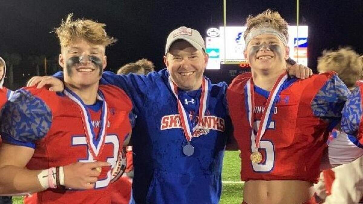 Hammond outside linebackers coach Dustin Etheridge, center, poses for a photo with Hammond players after winning the SCISA 3A championship in November. Etheridge has been named the new football coach at Hilton Head Prep.
