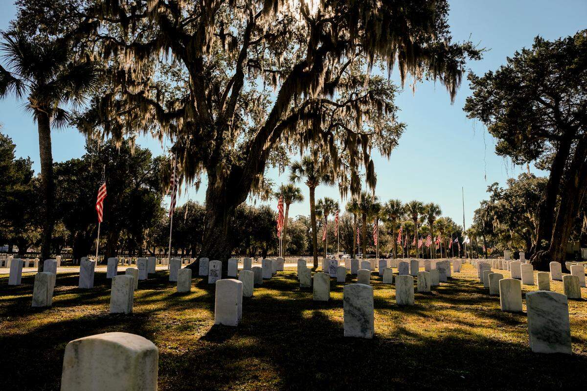 American flags line the main road into Beaufort National Cemetery as seen on Tuesday, Nov. 9, 2021, in preparation for Veterans Day.