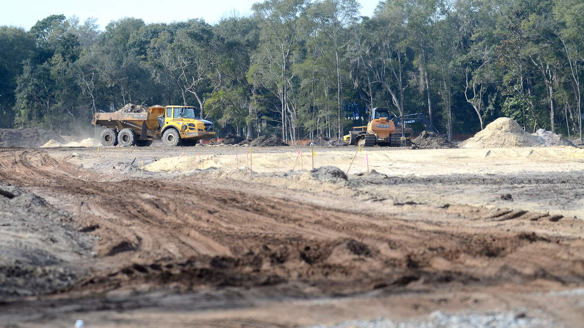 Land clearing continues on Wednesday at the Oyster Bluff construction site on Lady's Island. The developers of the site received a stop-work order for encroaching on established bluffers in clearing the 40 acres for the D.R. Horton housing project. But after workers restored the trees and shrubs within the buffers, work again resumed.