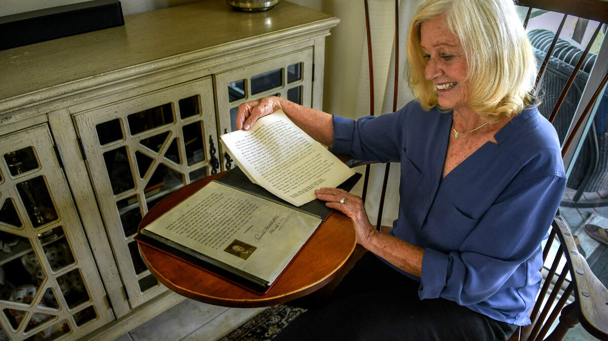 Anne Meara displays the type written essay that her grandfather Russell Mitcheltree wrote entitled “How to Make Democracy Live” while sitting on his circa 1930’s Windsor Writing Desk on Friday, June 30, 2023 at her Sun City Hilton Head home. Mitcheltree entered his essay in a 1948 Drew Pearson Radio Contest challenge sponsored by the Frank Lee Company and won the first place prize of $5,000. In today’s buying power the U.S. Bureau of Labor Statistics inflation calculator places that amount at more than $63,000.