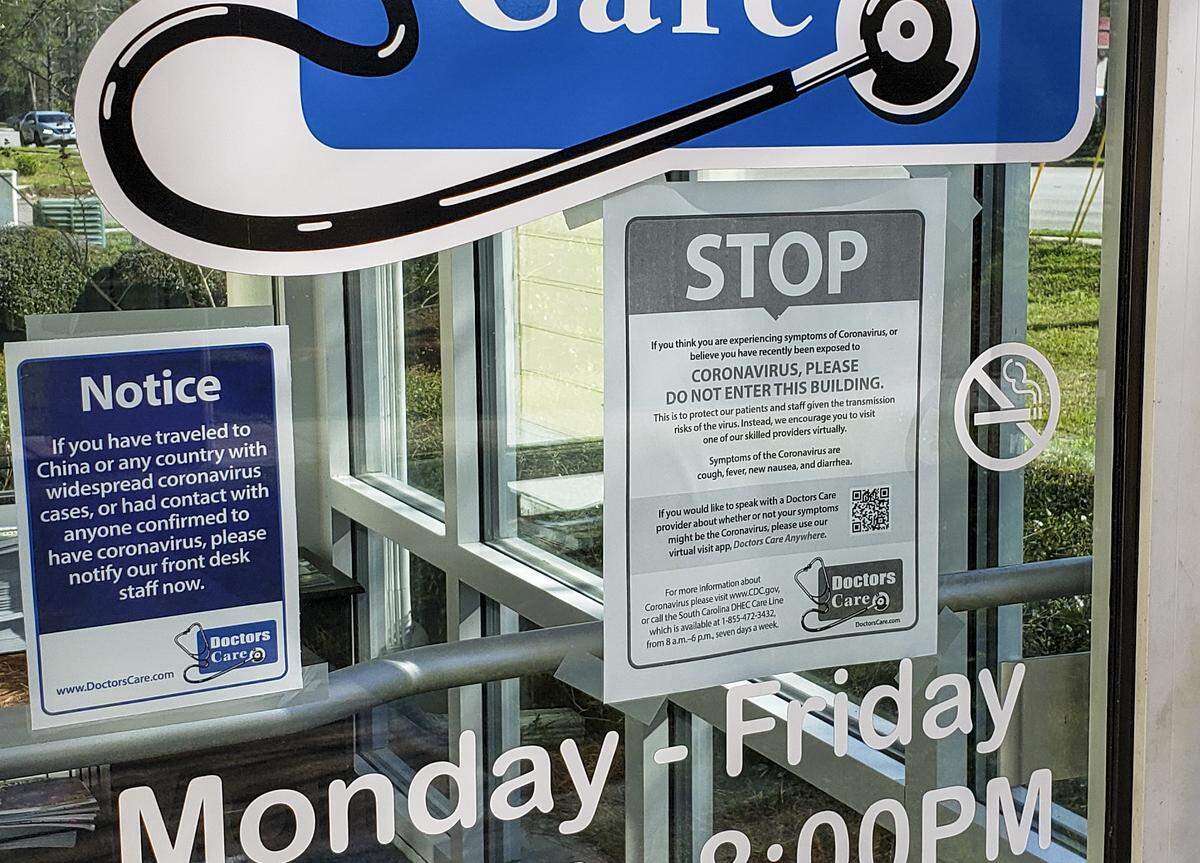 Two signs on the door of Doctor’s Care on Goethe and Bluffton roads, as seen on Thursday, March 12, 2020, tell patients if they’ve been to China or another country with widespread COVID-19 cases to notify the front desk immediately. The other signs asks patients not to enter if they think or have been diagnosed with the Coronavirus not to enter the facility but to use their virtual visit app if they’d like to speak to a doctor about their symptoms.  