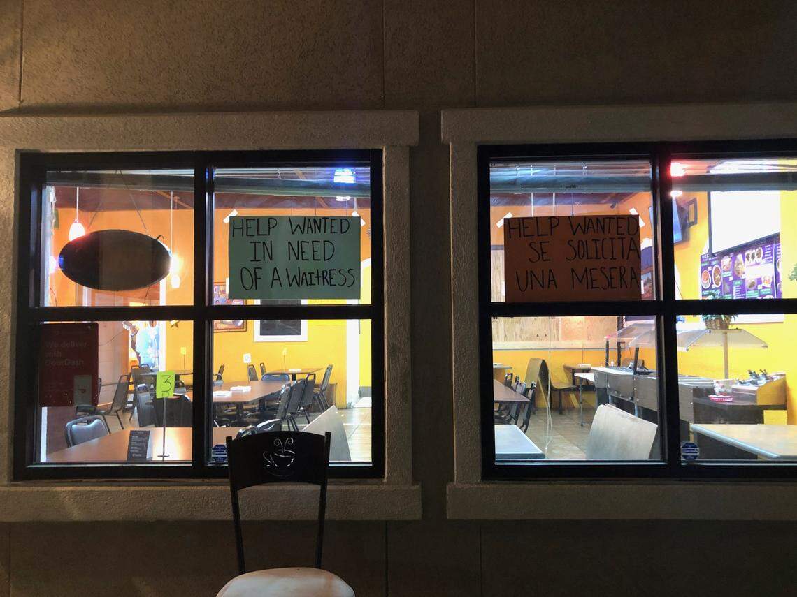 Signs at La Tampiqueña Mexican Restaurant in Bluffton, South Carolina, express the need for wait staff. The nation is seeing a workforce shortage as more become vaccinated and reenter the public. Many have blamed unemployment benefits for demotivating people from coming back to work.