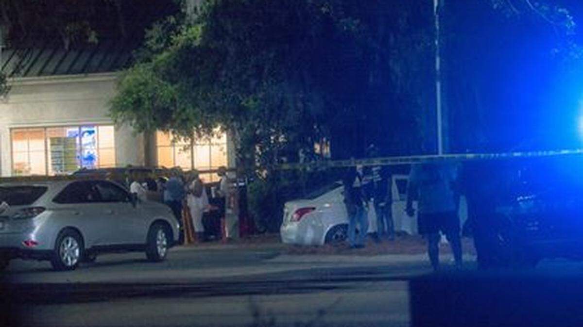 A crowd forms as police investigate a shooting Monday night in the CIrcle K parking lot on Lady’s Island.