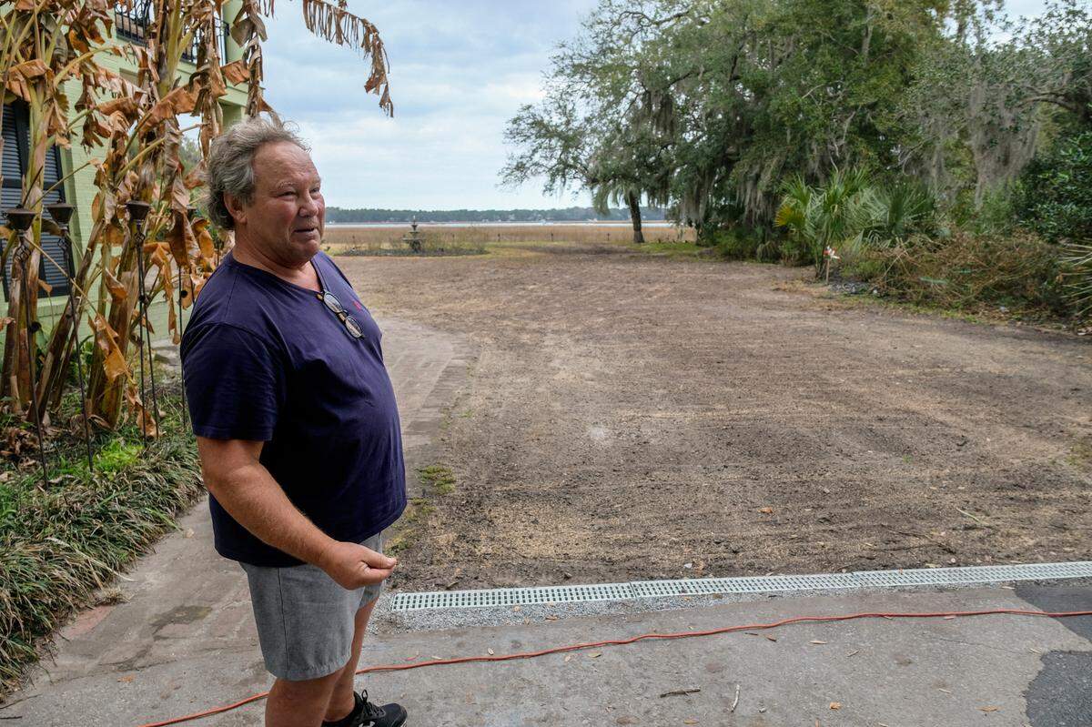 Steve Amaro stands in his driveway with his recently installed channel drain at his home in Beaufort’s historic neighborhood The Point on Friday, Feb. 4, 2022. Amaro, who bought their home prior to Hurricane Matthew’s arrival, says heavy rains turn their driveway into a river and is hopeful that the city’s plan to address stormwater control issues brings them some relief.