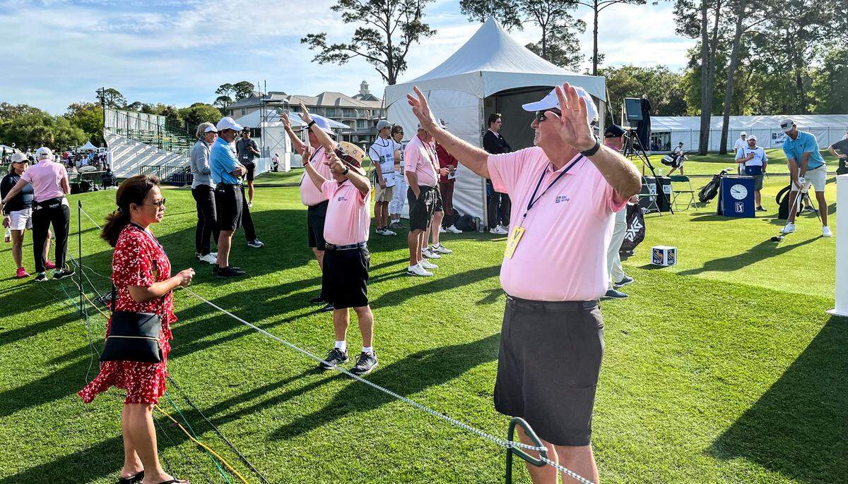 Under partly cloudy skies, a Pro-Am at the RBC Heritage Presented by Boeing kicked off on Wednesday, April 13, 2022 at Harbour Town Golf Links in Sea Pines on Hilton Head Island. Lynn Nguyen, of Hilton Head, watched as pro Michael Gligic teed off at the Pro-Am. Nguyen’s son, Michael, was holding the scoring sign.