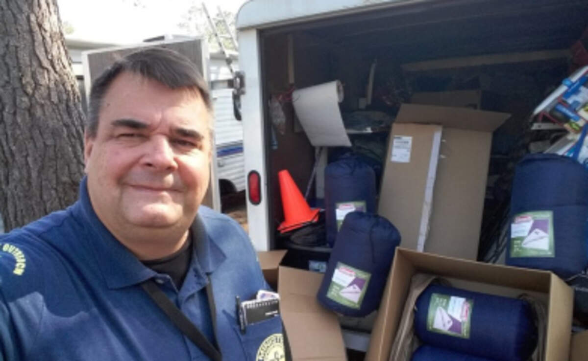 Preacher Tom Anderson, who has worked in aiding the homeless and the poor for 30 years stands in front of a truck with donated tents for the homeless.
