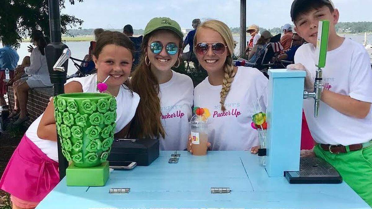 Proprietors Anne-Murphy, left, and Nate Miller, right, work with helpers Mabrey Kolb and Madison Blake, at the lemonade stand June 23 at Beaufort's Waterfront Park.