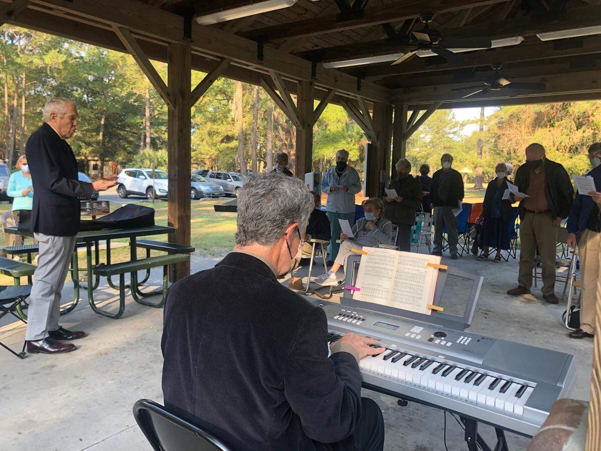 John Miller, left, leads the Chapel Without Walls congregation in song as Scott Camp plays the keyboard on March 14, 2021.