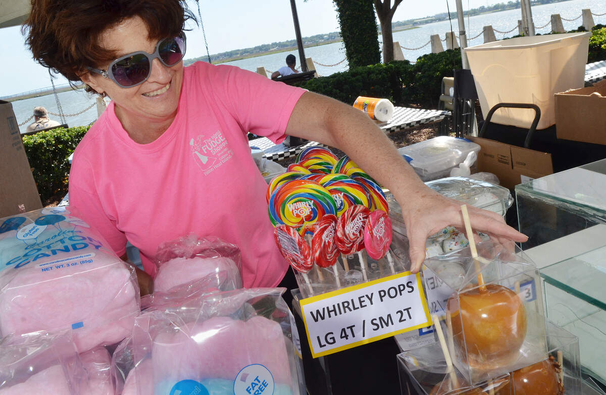 Maureen Robinson, of The Island Fudge Shoppe on Hilton Head Island, sets up her booth for A Taste of Beaufort on Friday evening at Beaufort’s Henry C. Chambers Waterfront Park. The popular Beaufort food festival started on Friday and will continue on Saturday.