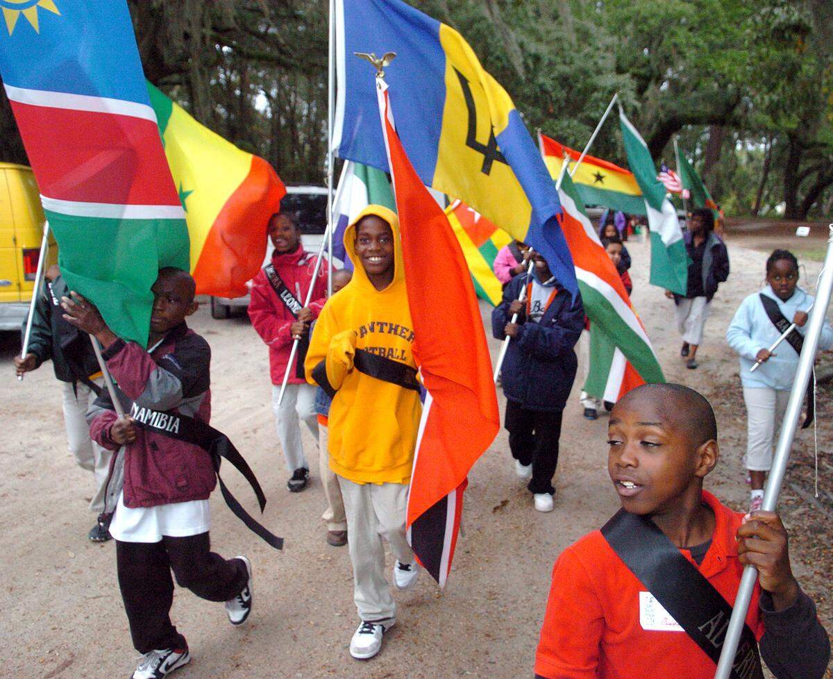 A group of Beaufort County students march on the Penn Center grounds during a presentation of the flags of the Gullah people on Thursday afternoon. The event was part of the opening ceremonies of 27th Annual Heritage Days. The festival runs through Saturday.