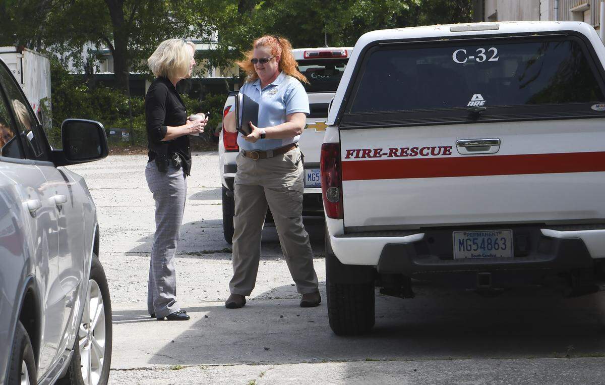 An investigator with the Beaufort County Sheriff’s Office, left, talks with Wendy Conant, a code enforcement officer with the Town of Hilton Head Island, Monday morning outside Meeting Dynamics, Special Event Production at Enterprise Park on Hilton Head Island. Caroline Smith, a 20-year-old Furman University sorority member, died early Saturday morning while at an off-campus event at the location.