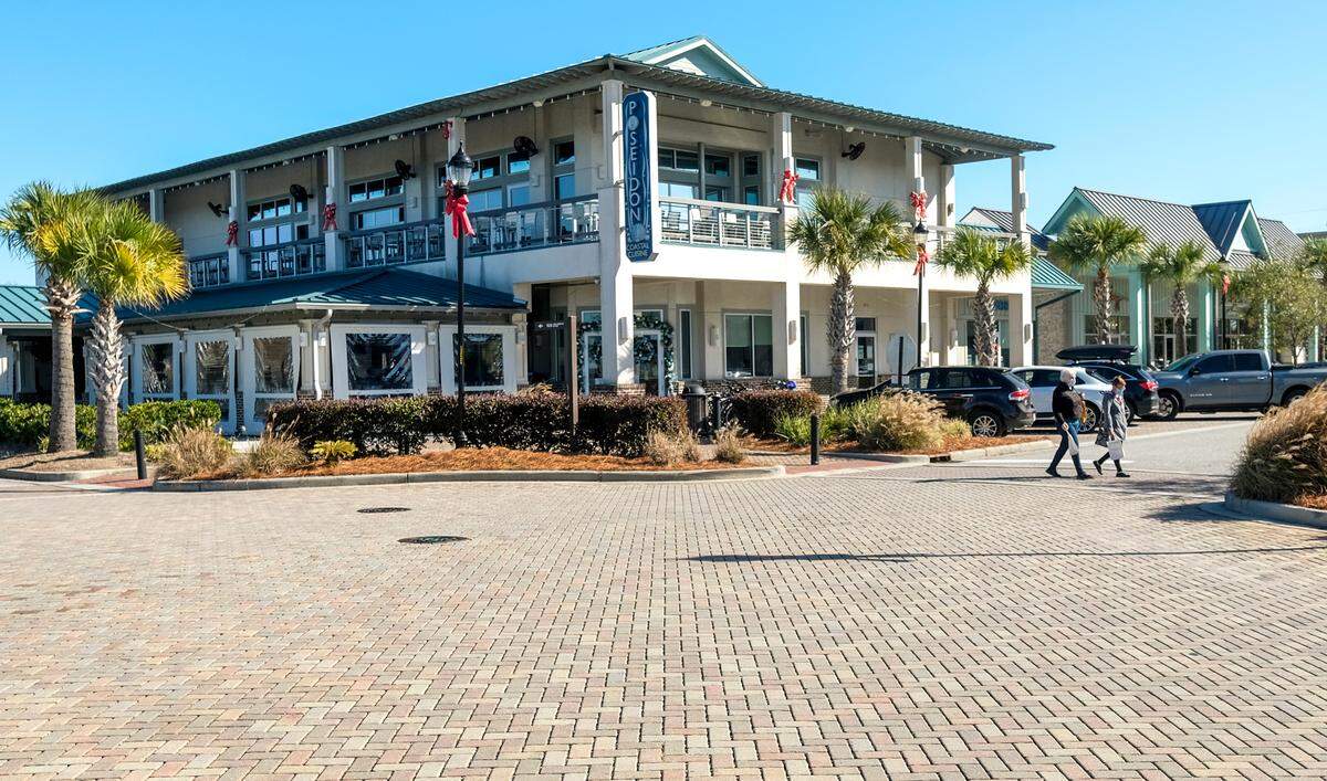 A bulletin board outside the Poseidon Coastal Cuisine in Shelter Cove Towne Centre announces a New Year’s Eve party on The Rooftop Bar as seen on Dec. 23, 2020 on Hilton Head Island. The flyer announces doors open at 7 p.m. but makes no mention of when festivities will end. On July 10, S.C. Gov. Henry McMaster passed an executive order barring alcohol sales after 11 p.m. to help stem the spread of the coronavirus.