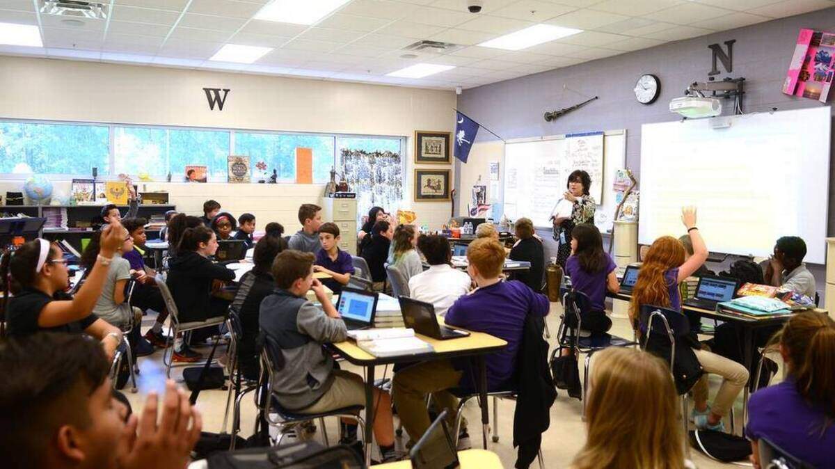 A sixth grade classroom at River Ridge Academy listens to their teacher on Thursday, Oct. 19, 2017 in Bluffton. This class has 42 students in it and is the largest class at River Ridge Academy.