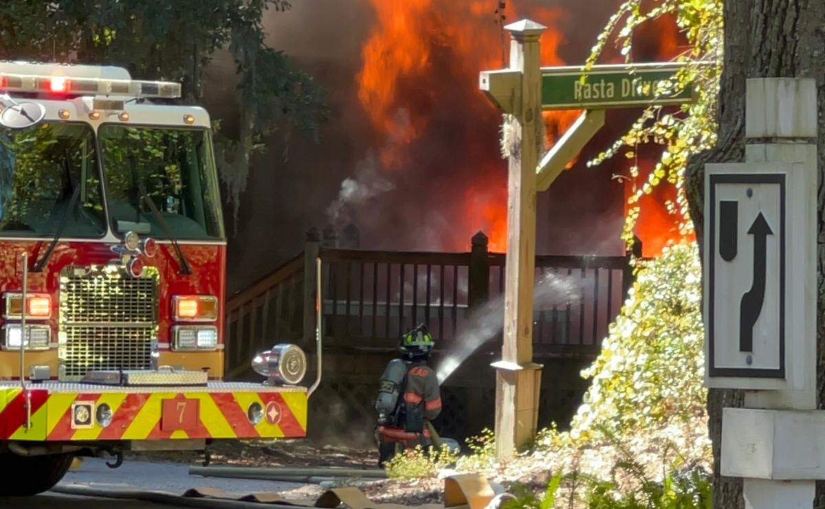Emergency personnel from Hilton Head Fire Rescue respond to the house fire on Rasta Drive on Sunday afternoon.