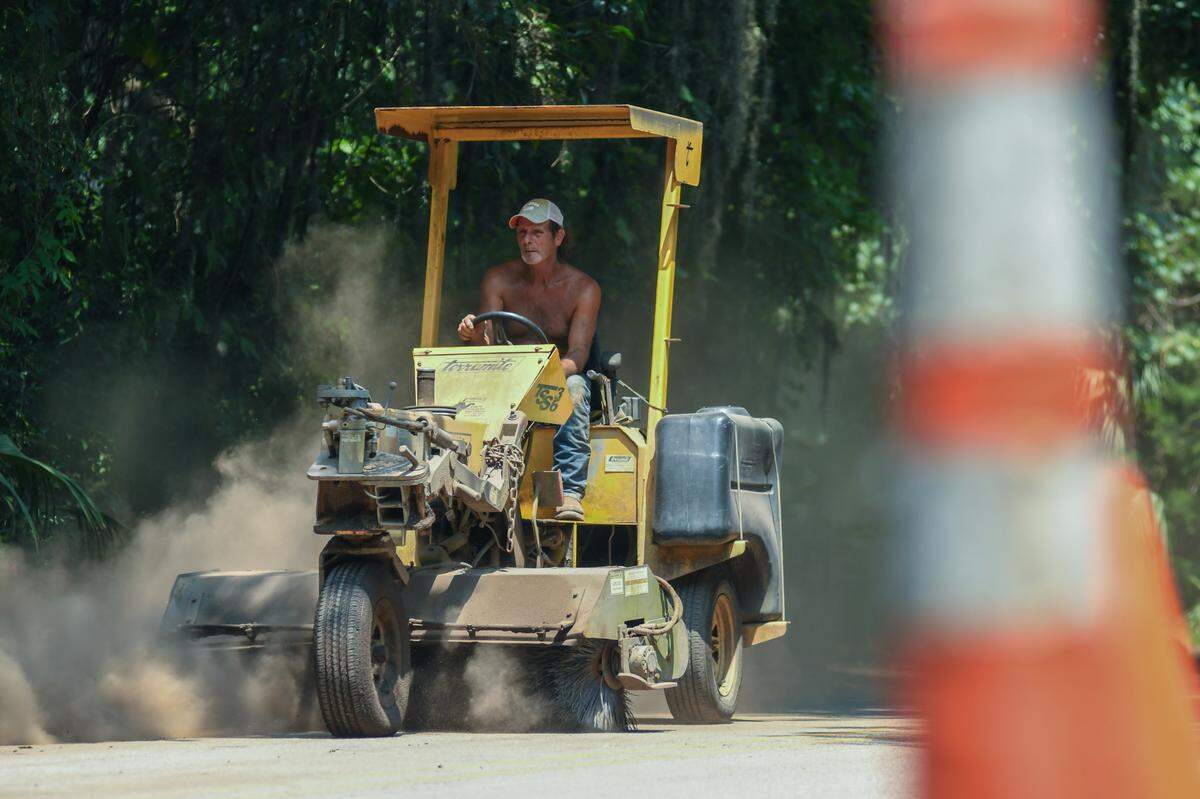 With heat index reaching into the 110s°F, ‘Cookie’ with Jordan Construction uses a broom tractor to clean up debris on Bridge Street on Wednesday, July 19, 2023 for tonight’s May River Shrimp Fest Sunset 5K in Old Town Bluffton. “We’re cleaning up the road for the race that’s coming through for the people that want to run in this stuff (heat),” he said after trying off the motor. When asked how he coped with the heat he said, “You have to work in it (excessive heat) to get used to it.”