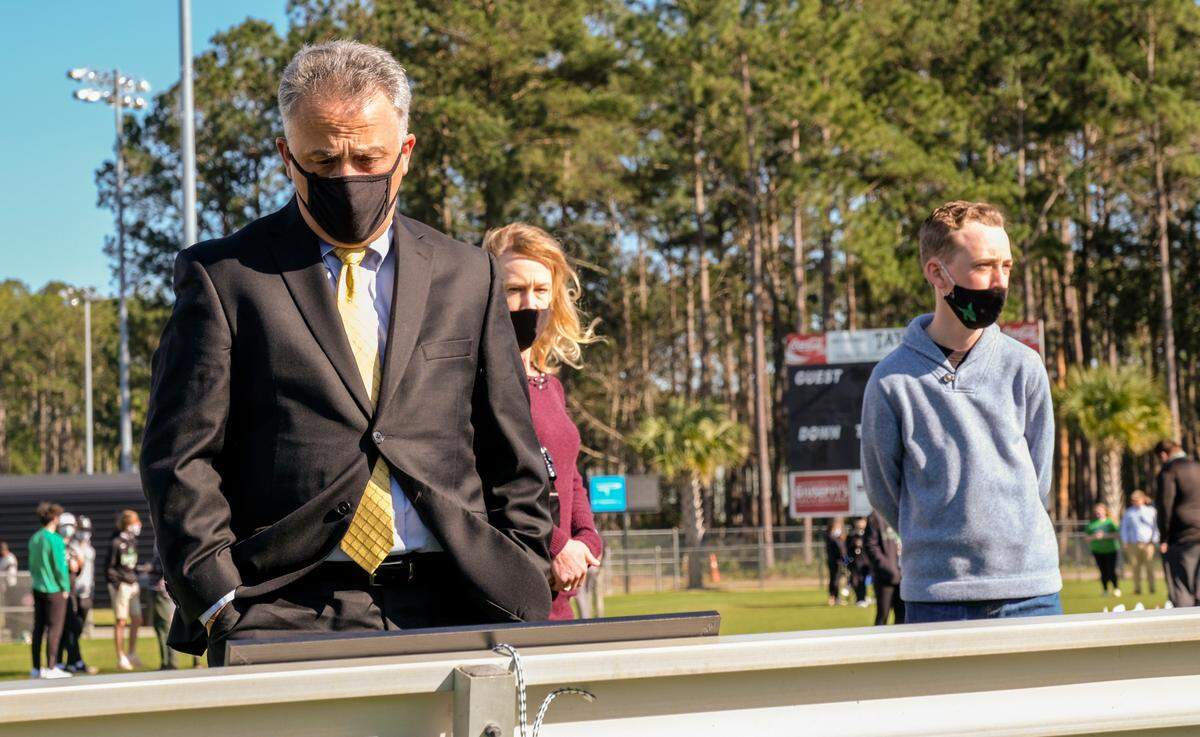 Beaufort County School District Superintendent Frank Rodriguez takes a moment at a bench full of photos of Dwon “DJ” Fields Jr. on Sunday, March 7, 2021 at Bluffton High School before the start of the public vigil. Fields was killed and two other Bluffton High students were taken to the hospital after the Friday shooting near Bluffton and Hampton parkways, Bluffton police said Saturday.