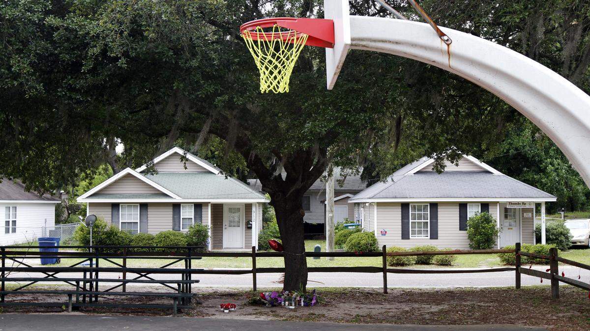 A makeshift memorial is seen below a tree along the basketball courts near the intersection of Greene Street and Hamar Street in Beaufort on May 7, 2015.