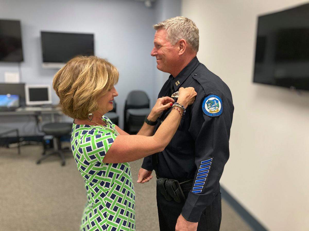 Lindy Gruel, new Beaufort Police Department deputy chief Darrell Gruel’s wife, pins him at his swearing-in ceremony.