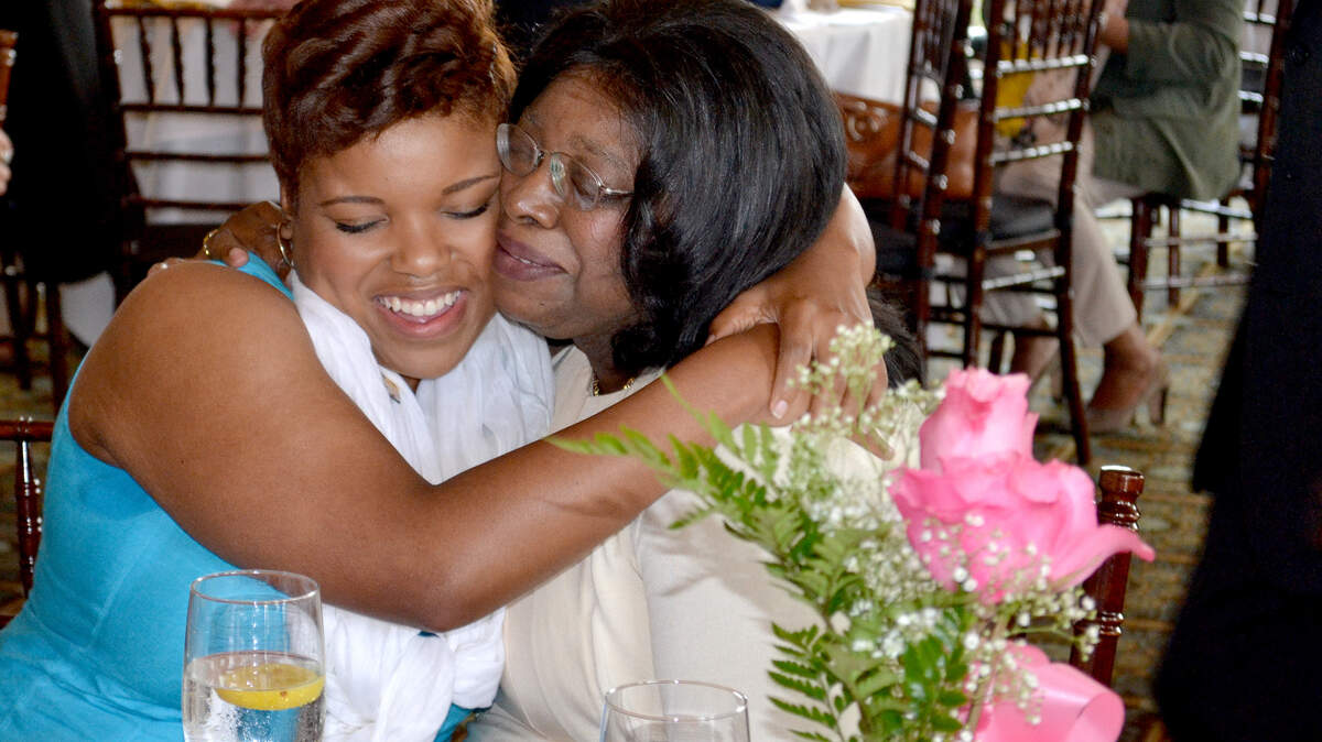 Whale Branch Middle School music teacher Amy Simmons, left, hugs her mother, Laura Simmons, a retired Beaufort County School District teacher, after being selected as the district's 2014-15 Teacher of the Year during a ceremony the morning of Sept. 19, 2014, at the Callawassie Clubhouse. Amy Simmons received a $5,000 check in recognition of her efforts, and she will now will represent Beaufort County in the state's Teacher of the Year competition.