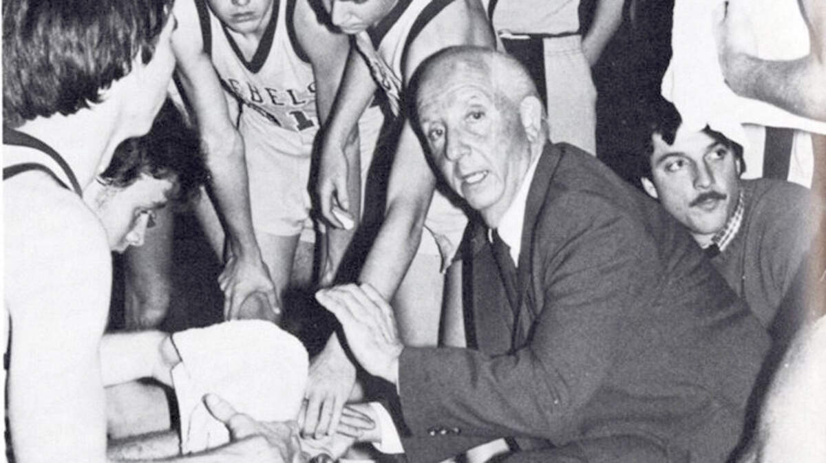 JuJu Hutson in a huddle with a 1980s basketball team at Thomas Heyward Academy in Ridgeland