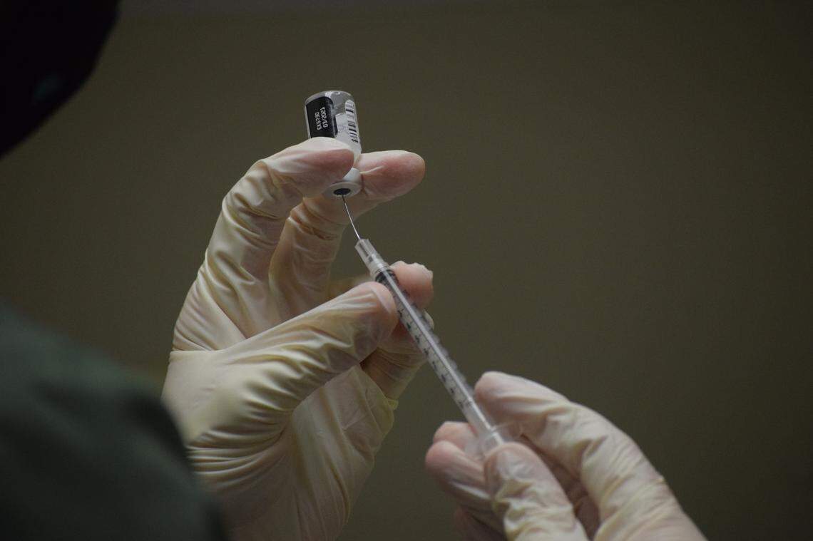 Erin Wornall, a pharmacist at Beaufort Memorial Hospital, draws a Pfizer-BioNTech coronavirus vaccine dose out of a vial on Monday, Dec. 21, 2020.