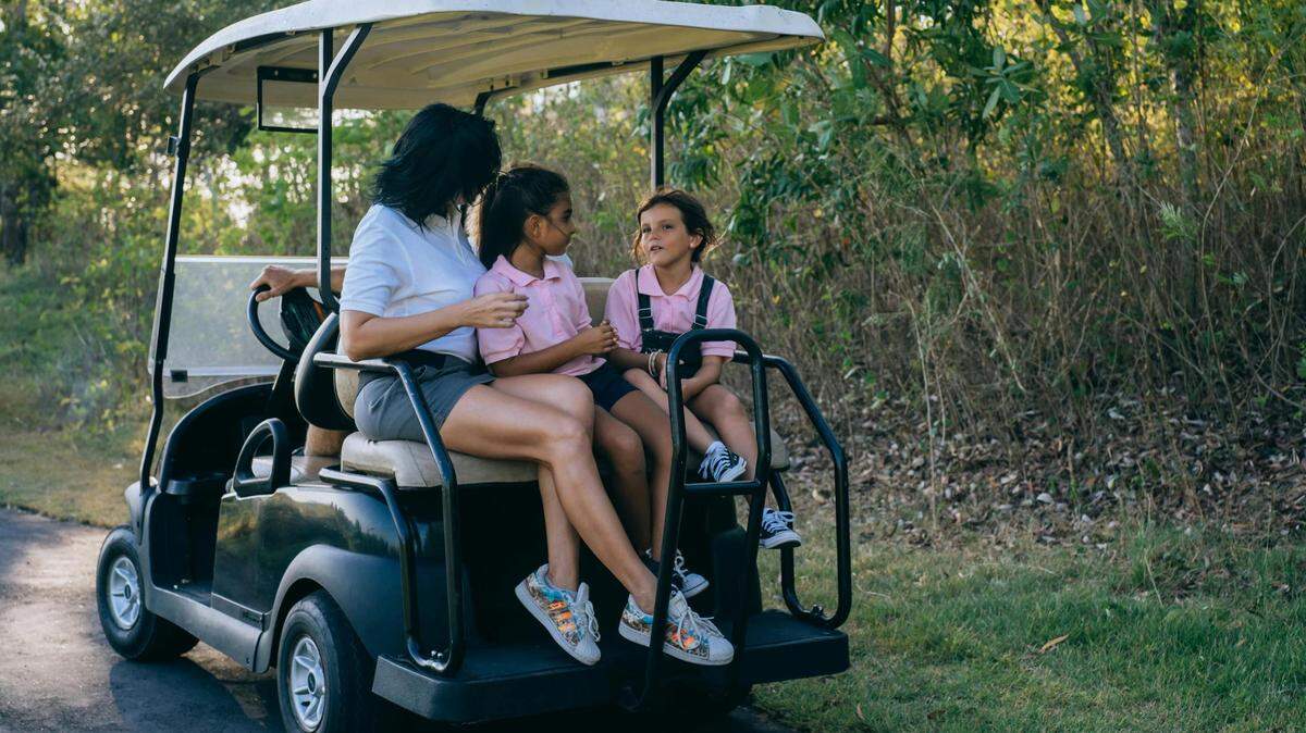 Family riding in a golf cart