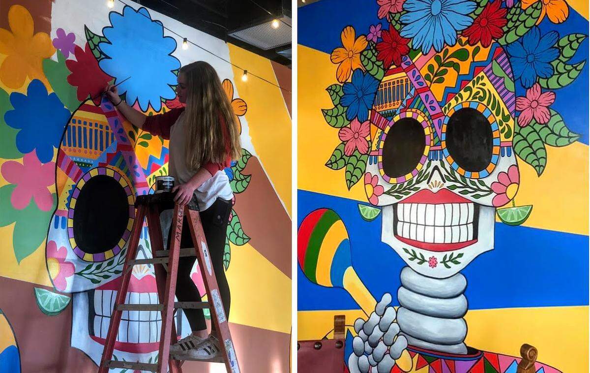 Charlotte Ofee (left) works on the mural at the new Tio’s Latin American Grill in Shelter Cove.