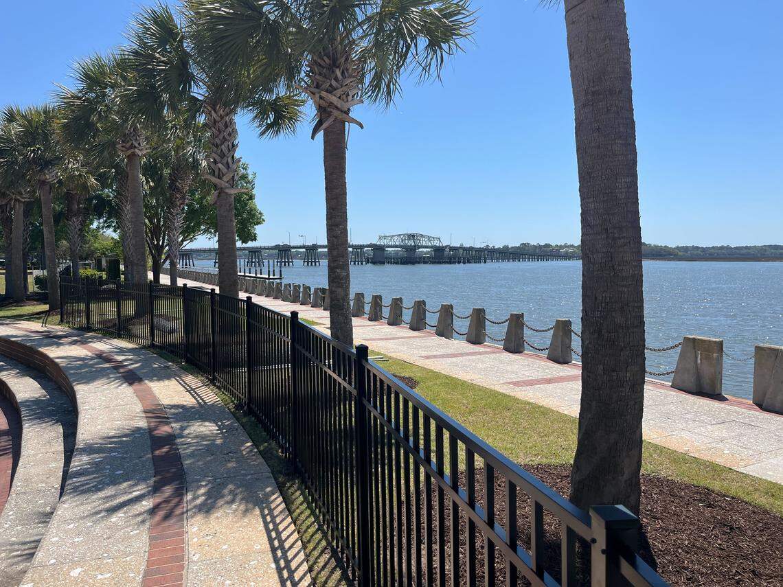 Woods Memorial Bridge and the Beaufort River are seen over a new fence the city of Beaufort is installing at Waterfront Park.