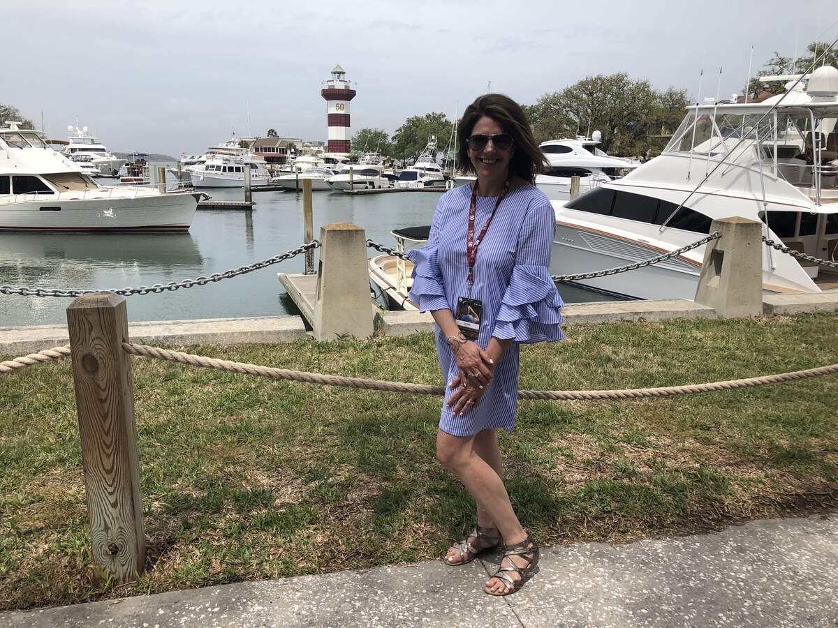 Kim Seaglund shows of her dress with blue stripes and big ruffled sleeves.