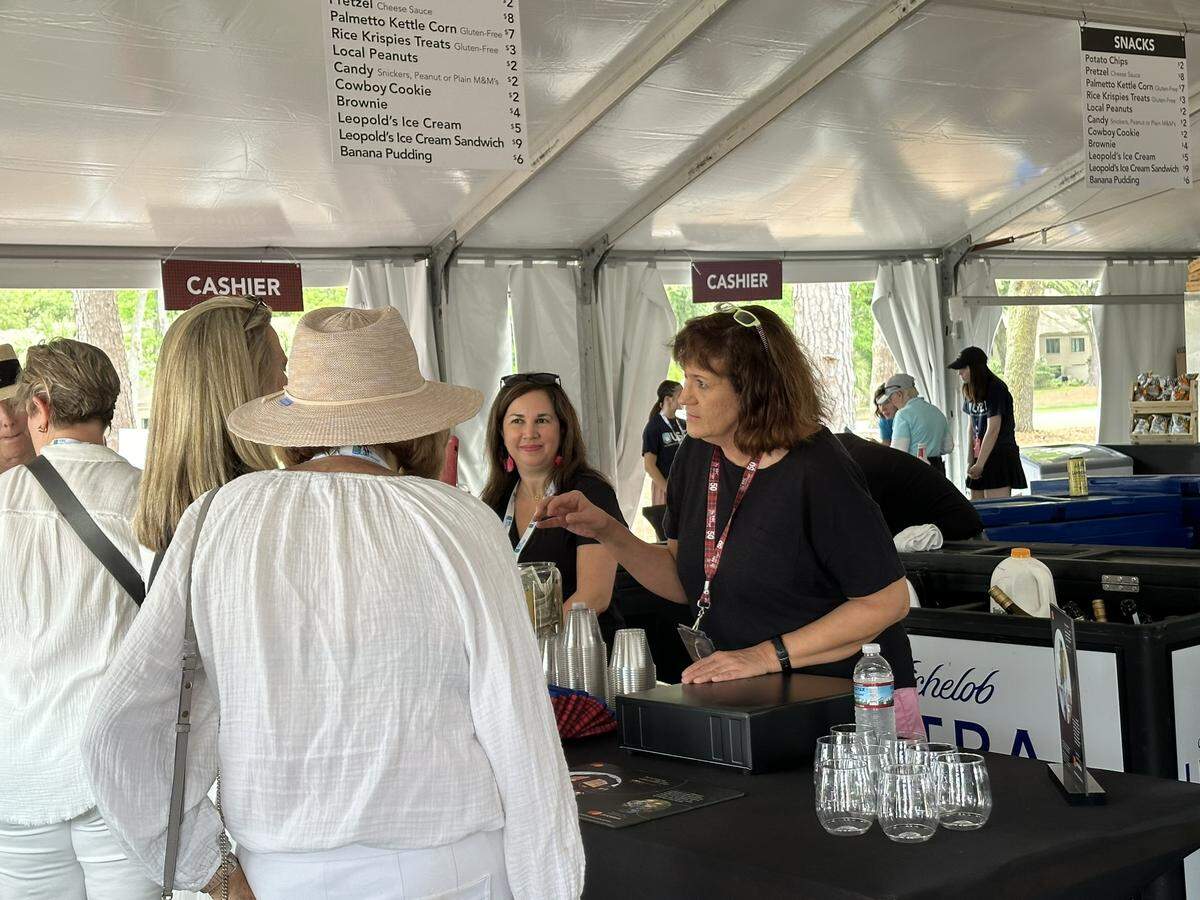 Town of Hilton Head Island FOIA compliance officer Faidra Smith (right) and paramedic Ana Piccioli greet attendees Wednesday morning at the town’s RBC Heritage concession stand.