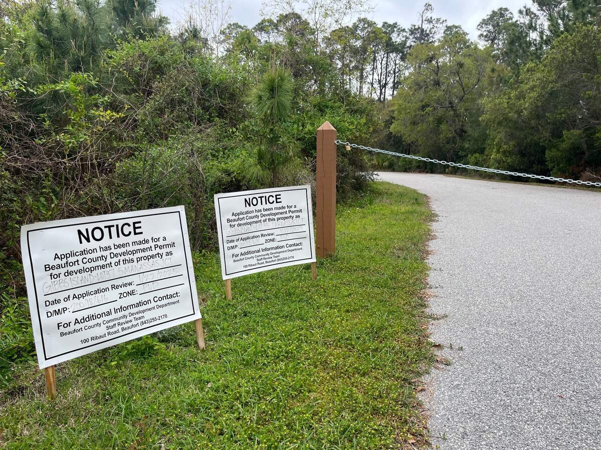 Signs inform the public that an application for a housing development has been received by Beaufort County off of Island Causeway on Gibbs Island, across from Secession Golf Club.