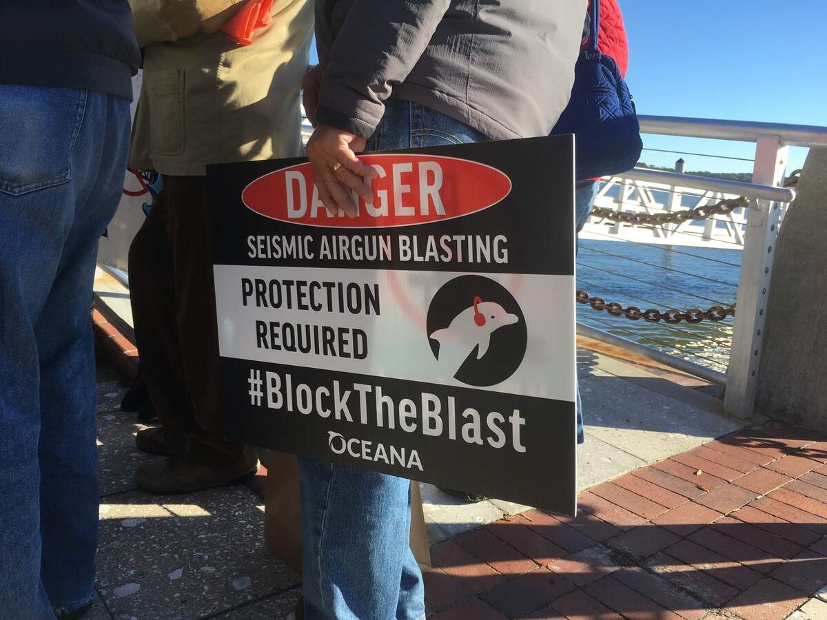 A sign held during a news conference in Beaufort’s Henry C. Chambers Waterfront Park on Dec. 11 objects to the effect of seismic testing on marine animals. Beaufort, Port Royal, Bluffton and Hilton Head were among 16 South Carolina cities to sue federal regulators in an effort to block permits for oil and gas exploration in the Atlantic Ocean.
