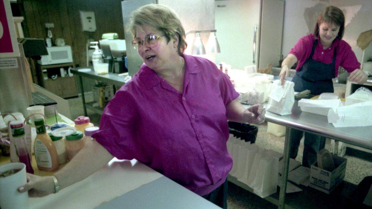Jody Caskey, mainstay for 20 years at the cash register of her greasy spoon, Jody’s Fine Food, is pictured doling out a drink to a customer in this file photo from October 9, 1996. Caskey is moving from Hilton Head Island to her hometown of Hendersonville, N.C.