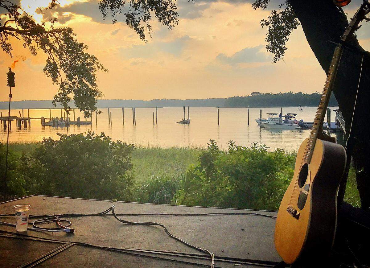 The sun sets over the water at the Skull Creek Boathouse.