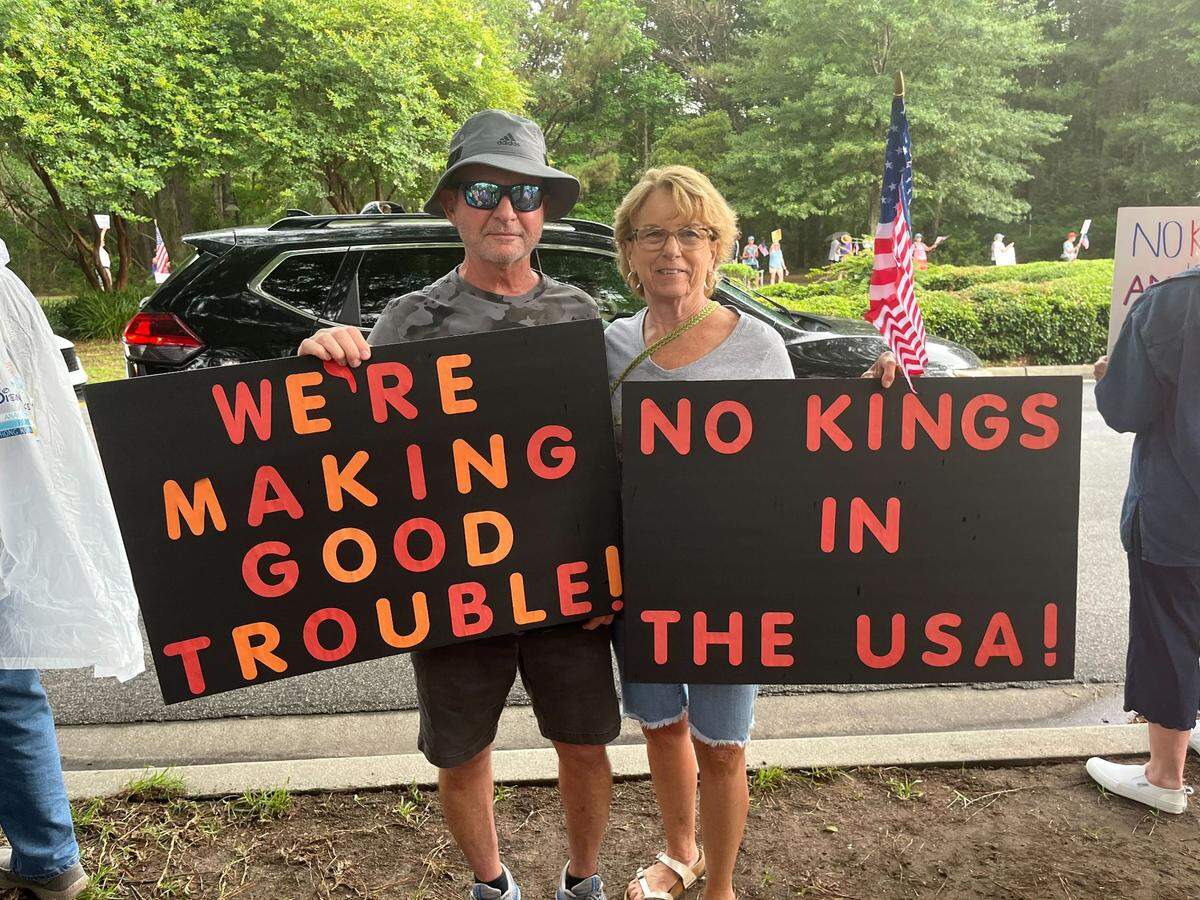 Goeff and Jo-Anne Bijas photographed with their signs at Bluffton’s “No Kings” protest on June 14, 2025.