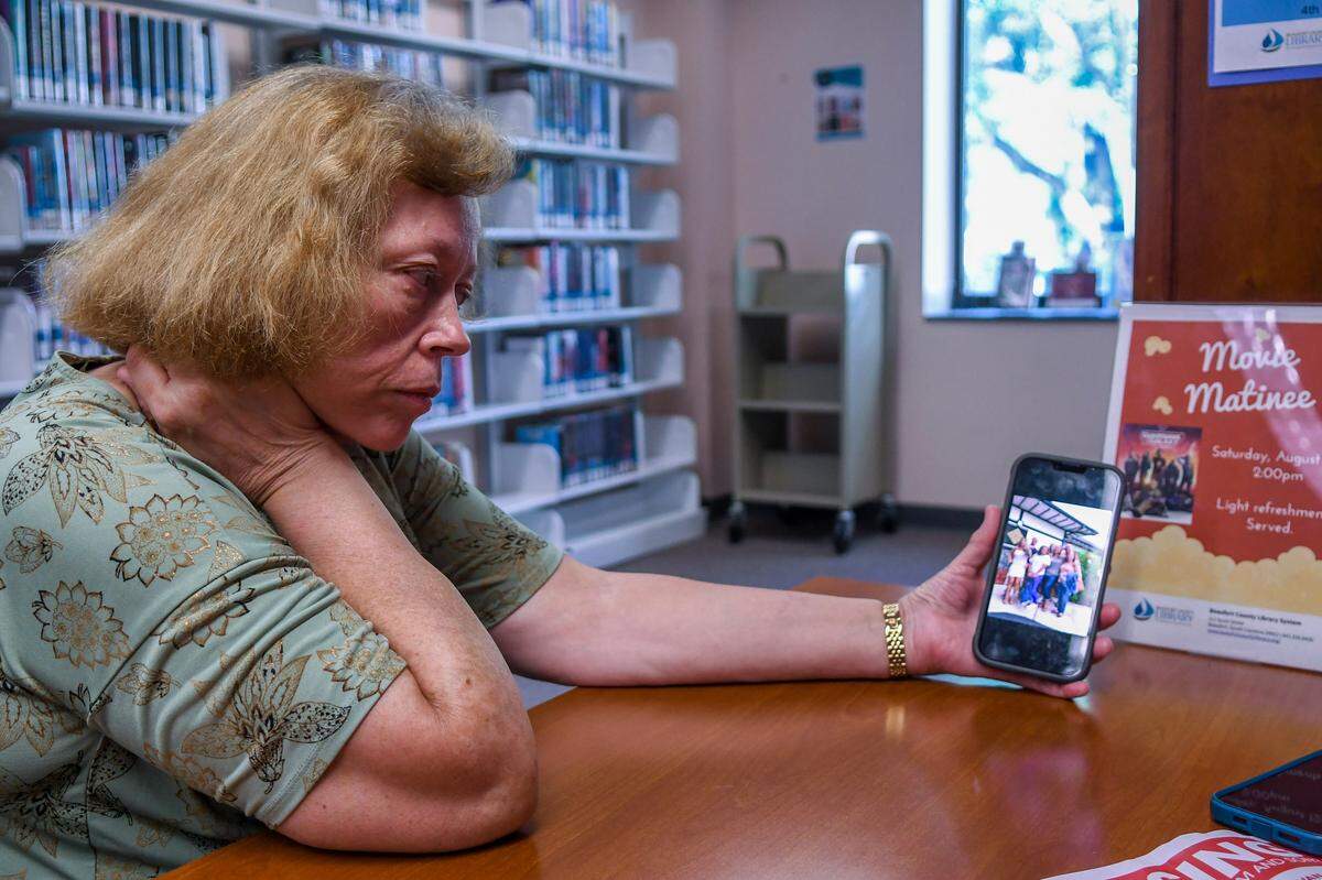 Theresa Van Dam, mother of missing Sophia Van Dam and her son Matteo, displays a family photo on Thursday, Aug. 10, 2023 at the Beaufort Library in downtown Beaufort. Van Dam is coming to grips that foul play may have been involved in her daughter’s disappearance but remains hopeful her grandson is safe.
