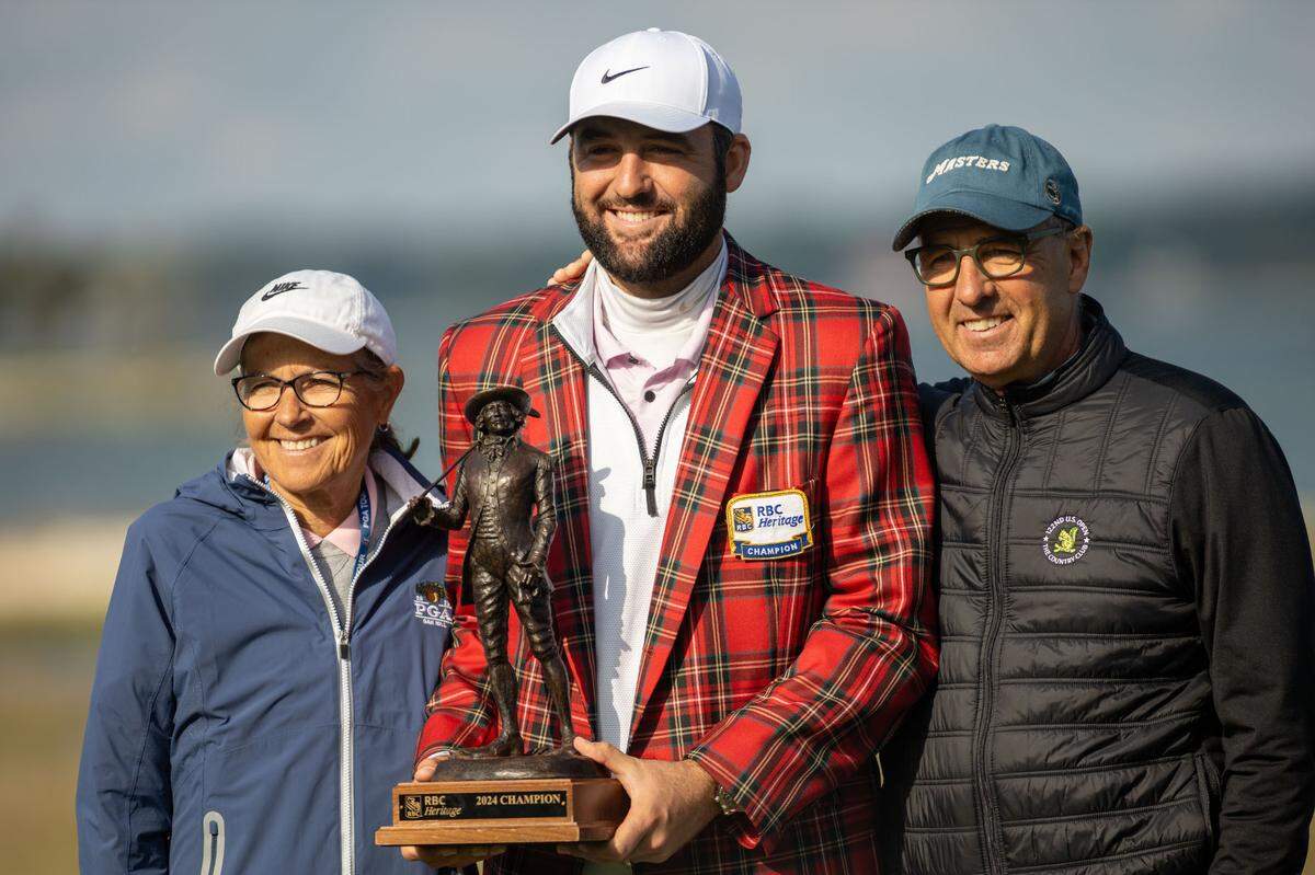 Scottie Scheffler and his parents pose with the Sir William Innes trophy after a rain delay pushed the final round of the RBC Heritage Presented by Boeing at Harbour Town Golf Links to Monday, April 22, 2024 in Sea Pines on Hilton Head Island.