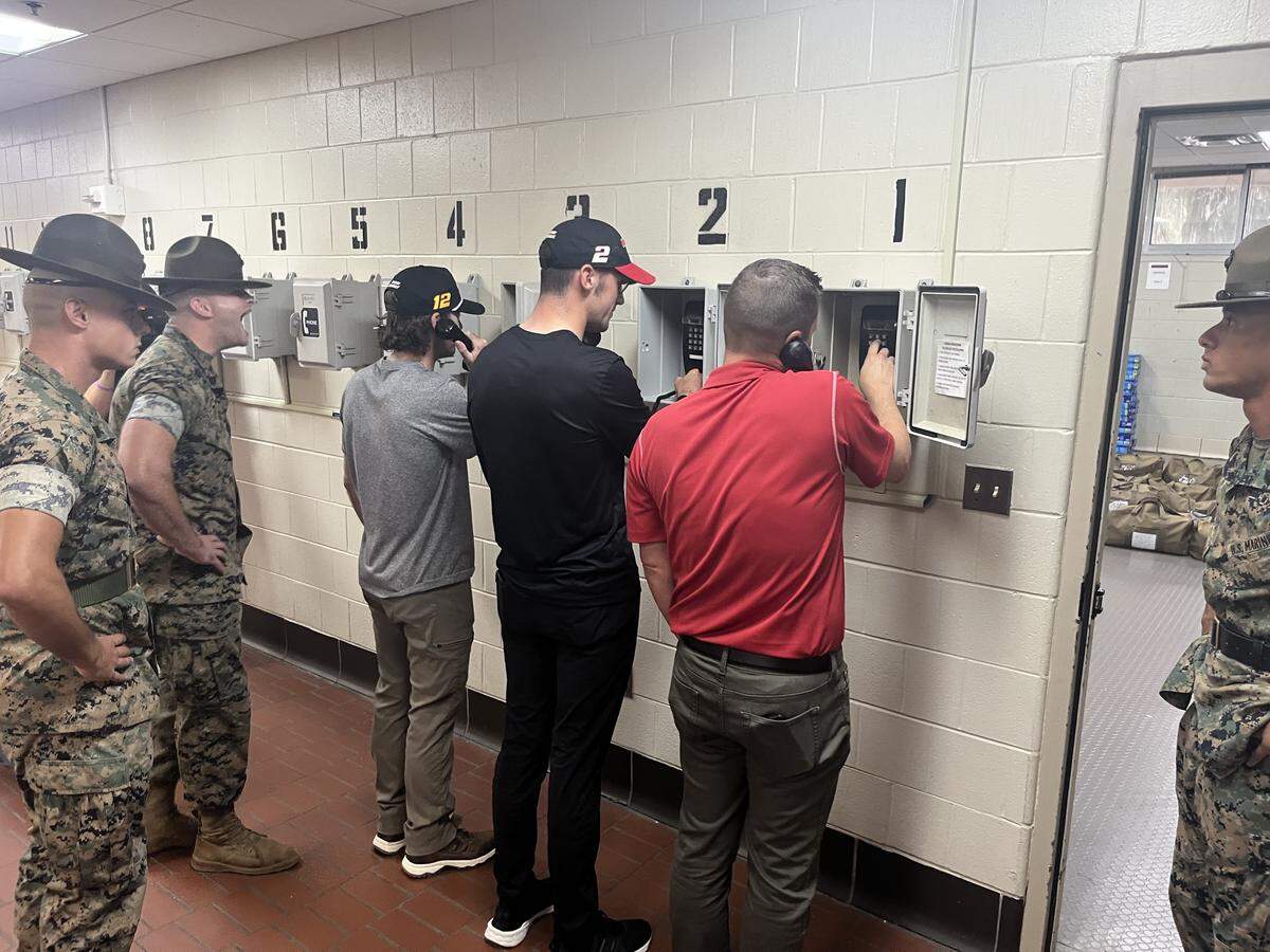 Professional race car drivers Ryan Blaney and Austin Cindric and Josh Harris of Darlington Raceway make phone calls to loved onces informing them they had arrived safety at U.S. Marine Corps Recruit Station Parris Island. Each of the 16,000 recruits that are received each year at the recruit station make the same phone call.