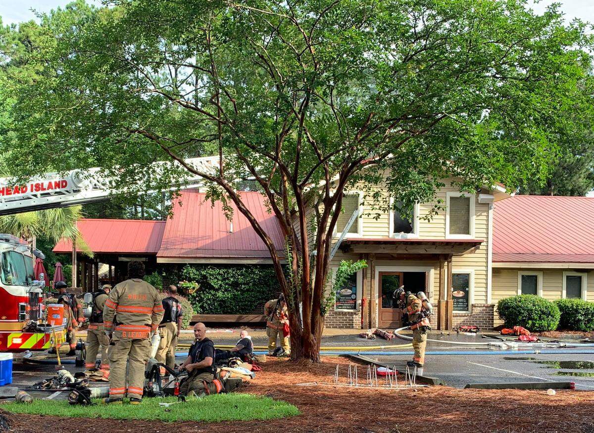 Hilton Head firefighters survey damage at The Smokehouse restaurant on Palmetto Bay Road after a fire on Sunday, June 9, 2019.