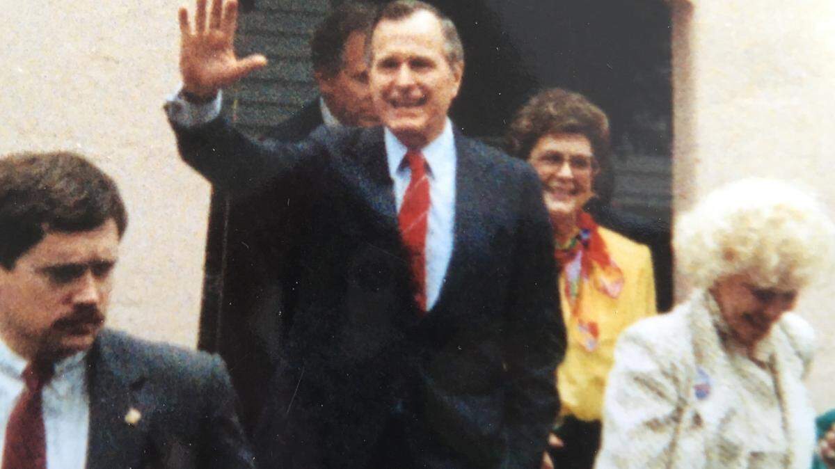 Vice President George H.W. Bush waves as he leaves the Beaufort home of Edie Rodgers, right in yellow, on March 4, 1988. Bush was campaigning in Beaufort before the Republican presidential primary.