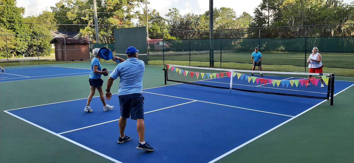 Bob Mullins whacks the ball during a pickleball game on a new court at Southside Park in Beaufort Wednesday morning. Mullins and his wife, across the net to the right, are still learning the game. “Anybody and everybody can play,” Gail says.