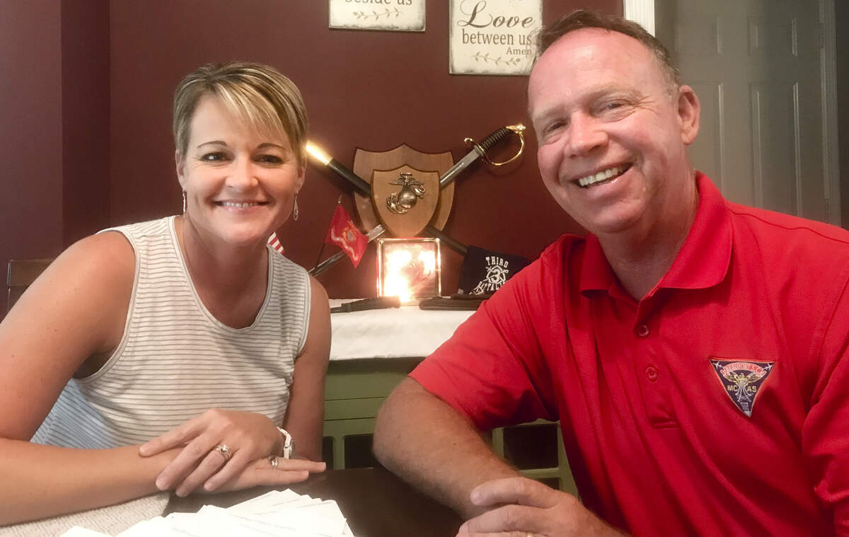 Joy and Rick McConnell pose for a picture Friday, Sept. 21, 2018, in their Beaufort, S.C., home. Behind them is a display of Marine Corps items dedicated to their son, Tucker, who was then training at Marine Corps Recruit Depot Parris Island.