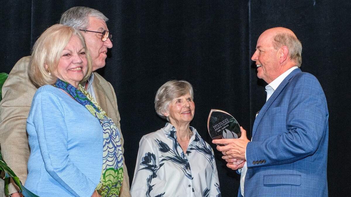 Bob Elliott, right, accepts the Community Impact Award from benefactors Joan and Wade Webster, left, and Community Foundation of the Lowcountry board chair Jackie Rosswurm.