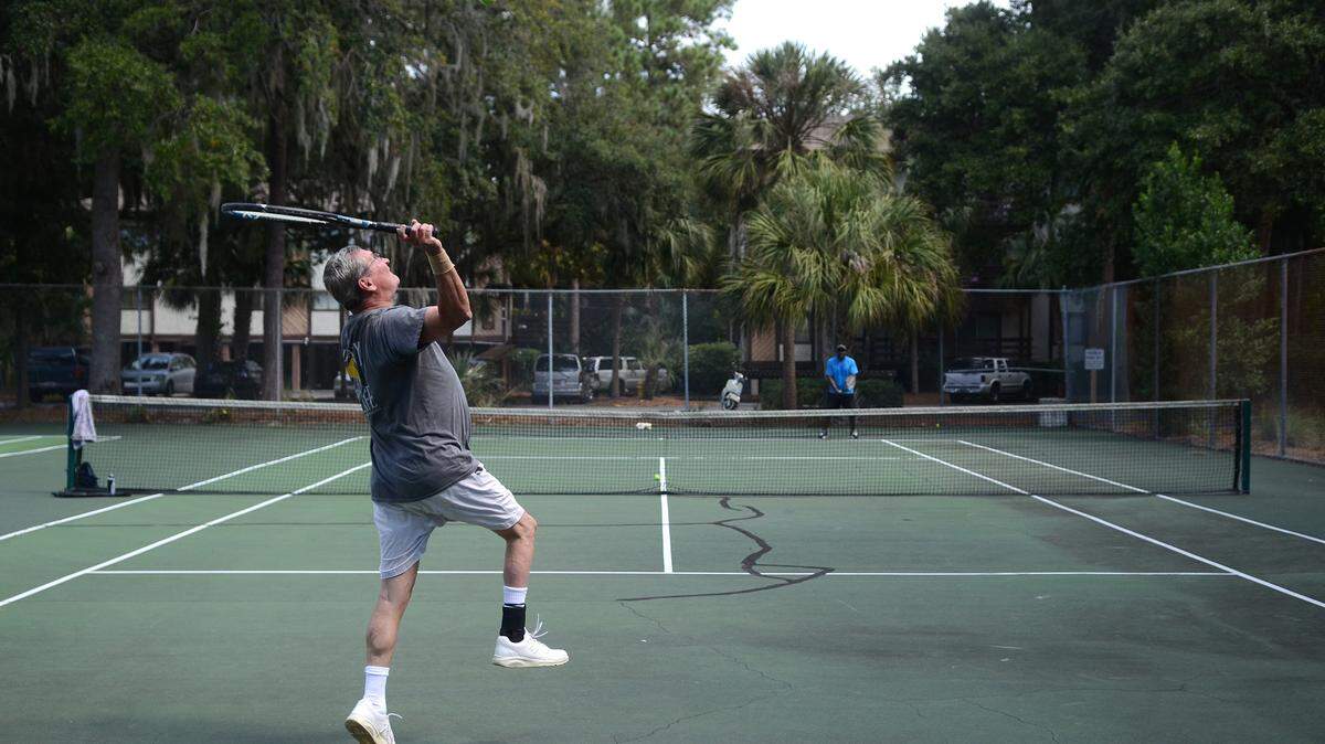 Gerry Griesbaum, of Pottsville, Pa., serves the ball to his tennis partner, Tracy Solomon, of Fairfax, Va., the afternoon of Oct. 7, 2014, at Cordillo Parkway courts on Hilton Head Island. The town of Hilton Head Island is considering selling the courts.