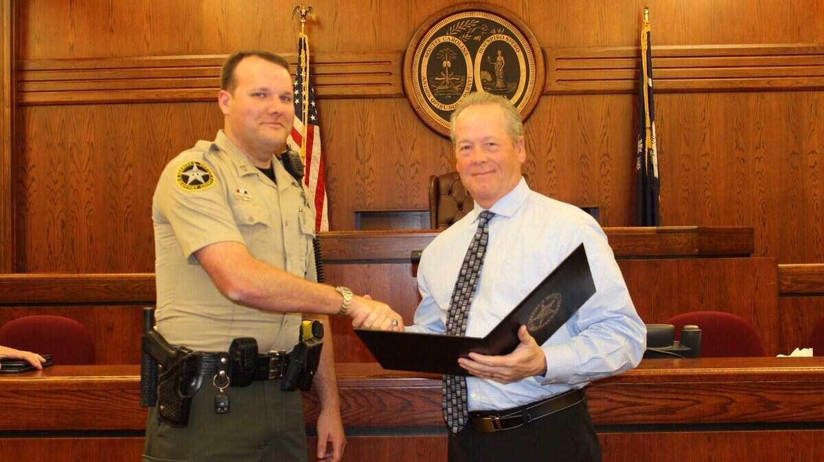 Beaufort County Sheriff’s Office Cpl. John Keener, left, is recognized by Sheriff’s P.J. Tanner in April. Keener was attacked by a dog and injured during a call on Aug. 16. He returned to work Friday.