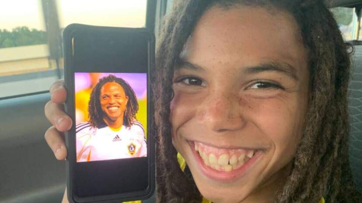 Jerrieme “L.J.” Washington smiles alongside a photo of Cobi Jones, a former professional soccer player from the Los Angeles Galaxy. The 14-year-old was killed in a drive-by shooting the night of Jan. 1 at his home in Burton.