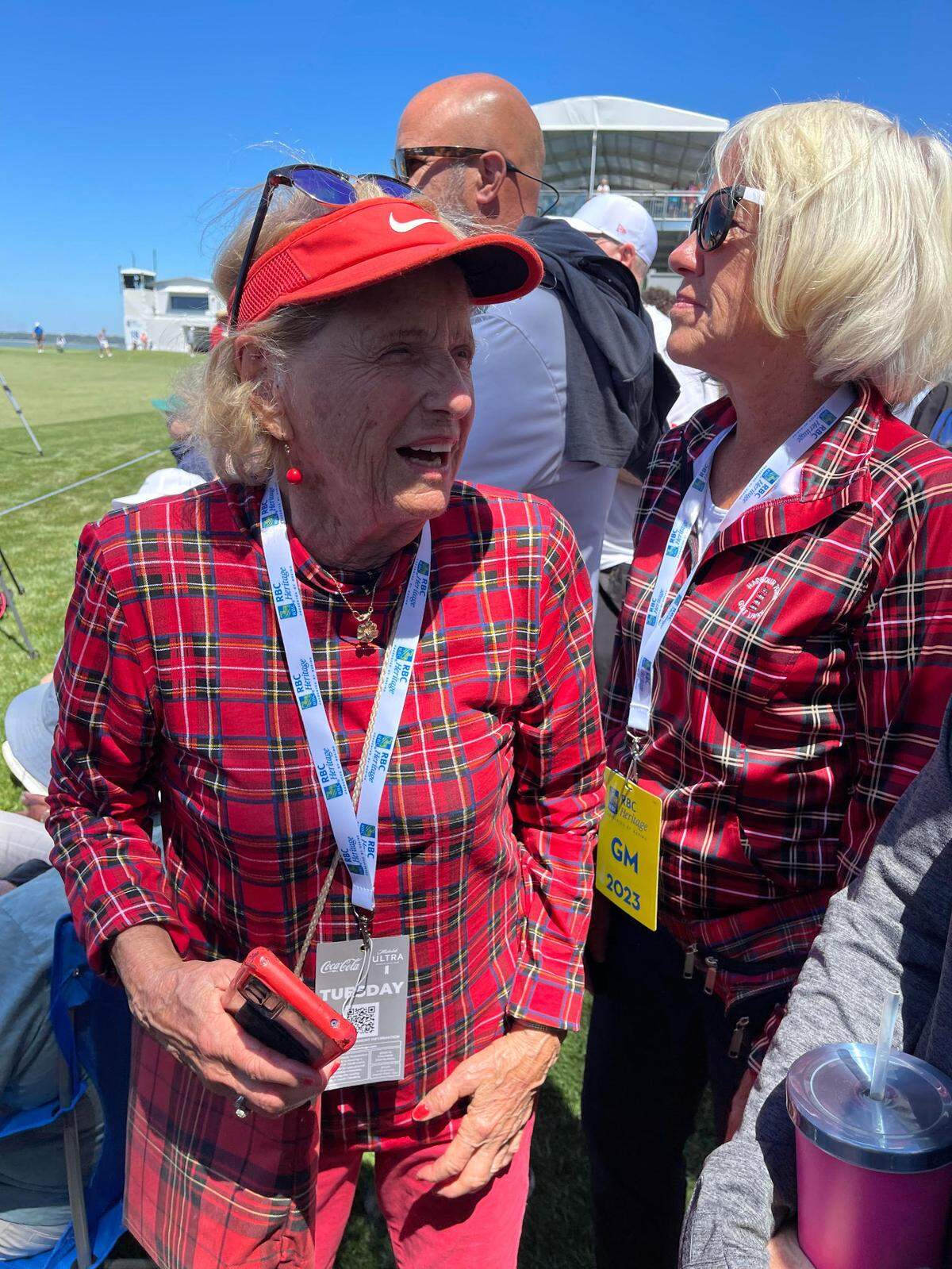 Betsy Geary with her friend dressed in plaid at the RBC Heritage in 2023.