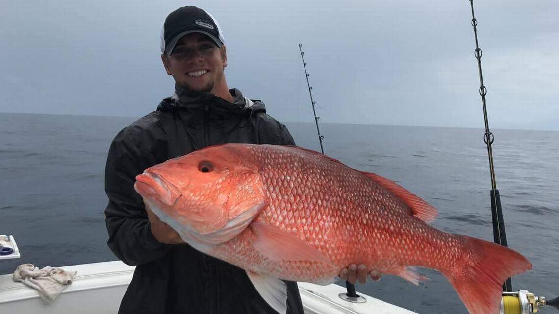 An angler off the coast of South Carolina poses with a red snapper he caught during the first weekend-long “miniseason” of 2017.
