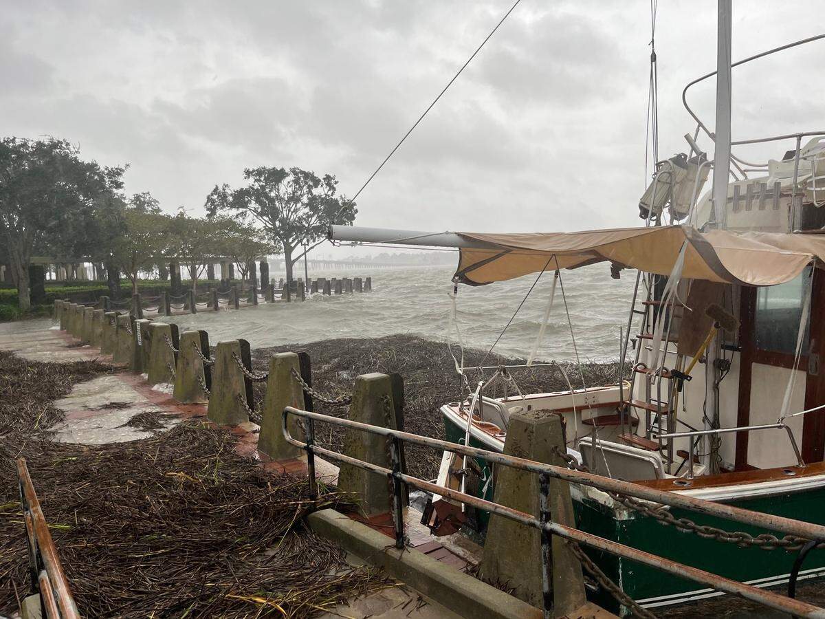 High winds push a boat in the Beaufort marina against the promenade Friday morning.